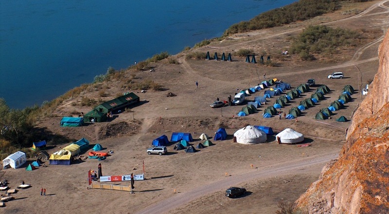 Camp of tourists on coast of the river Ili.